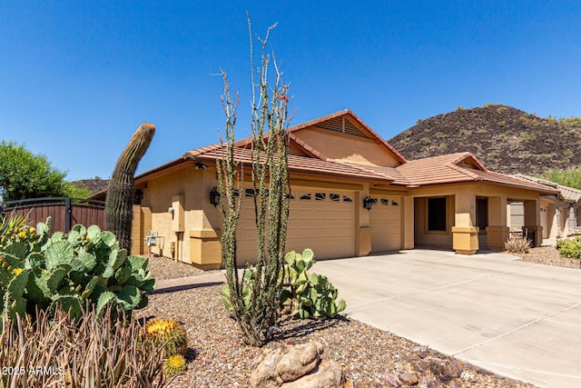 3028 W Parkside Ln, Phoenix, AZ 85027 - view of front facade with a garage, stucco siding, fence, a tile roof, and driveway