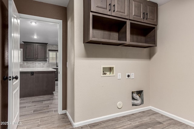 3028 W Parkside Ln, Phoenix, AZ 85027 - laundry room with electric dryer hookup, hookup for a washing machine, light wood-style flooring, gas dryer hookup, and cabinet space