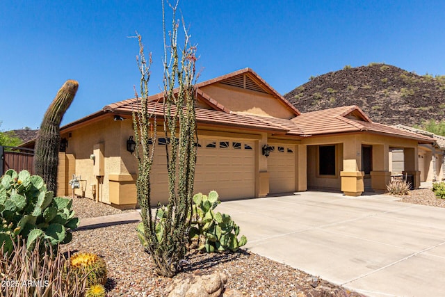 3028 W Parkside Ln, Phoenix, AZ 85027 - ranch-style house with a garage, a tiled roof, stucco siding, driveway, and a mountain view