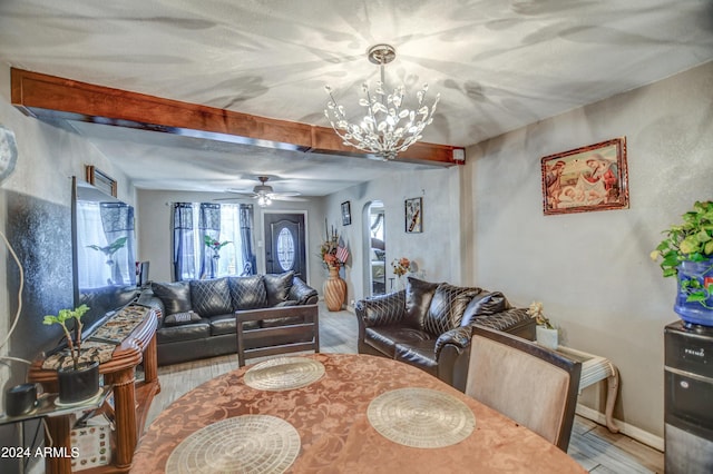 2124 W Maricopa St, Phoenix, AZ 85009 - living area with a chandelier, beamed ceiling, wood finished floors, a ceiling fan, and baseboards