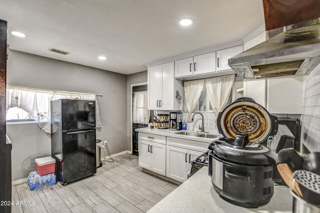 2124 W Maricopa St, Phoenix, AZ 85009 - kitchen with freestanding refrigerator, a sink, baseboards, white cabinetry, and recessed lighting