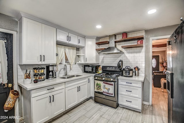 2124 W Maricopa St, Phoenix, AZ 85009 - kitchen with range with gas stovetop, wall chimney exhaust hood, open shelves, a sink, and light countertops
