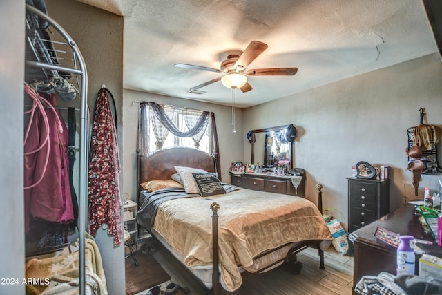 2124 W Maricopa St, Phoenix, AZ 85009 - bedroom featuring wood finished floors, a textured ceiling, and a ceiling fan