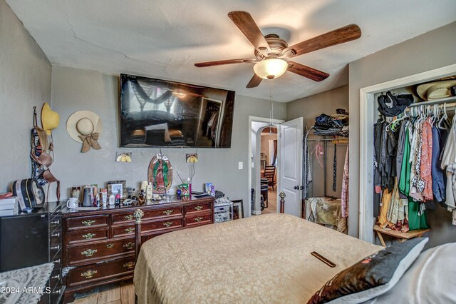 2124 W Maricopa St, Phoenix, AZ 85009 - bedroom with a closet, wood finished floors, ceiling fan, and arched walkways