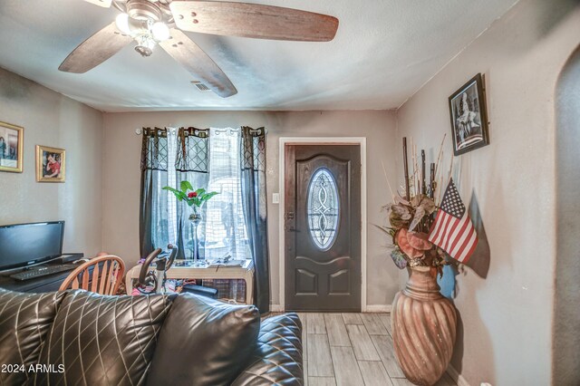 2124 W Maricopa St, Phoenix, AZ 85009 - foyer entrance with wood tiled floors, a ceiling fan, and baseboards