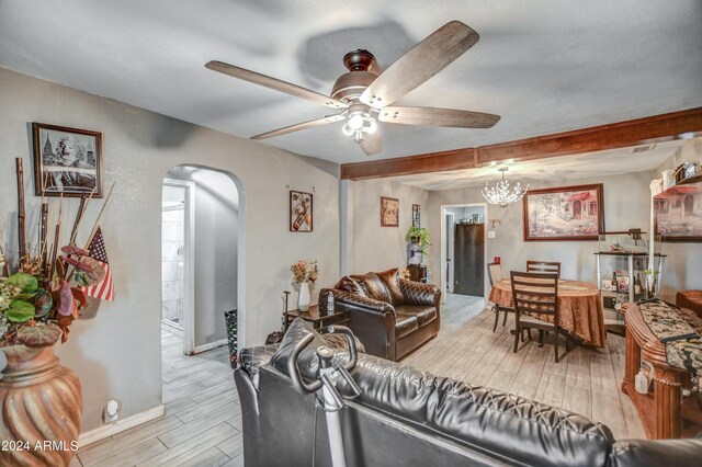 2124 W Maricopa St, Phoenix, AZ 85009 - living area with arched walkways, light wood-type flooring, a ceiling fan, baseboards, and a chandelier