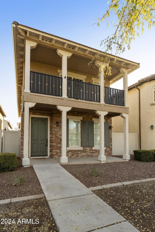 view of front of home with a balcony and covered porch