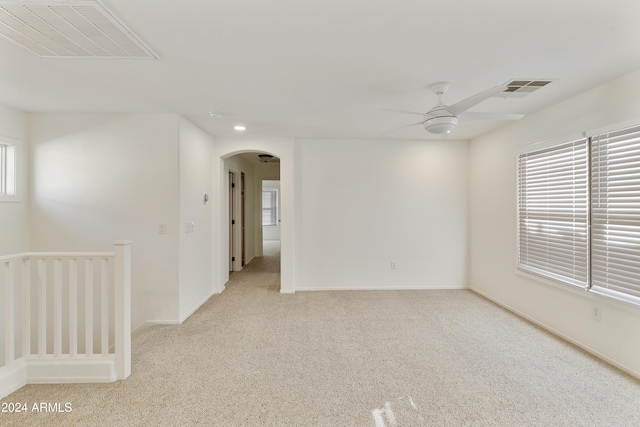 carpeted empty room featuring ceiling fan