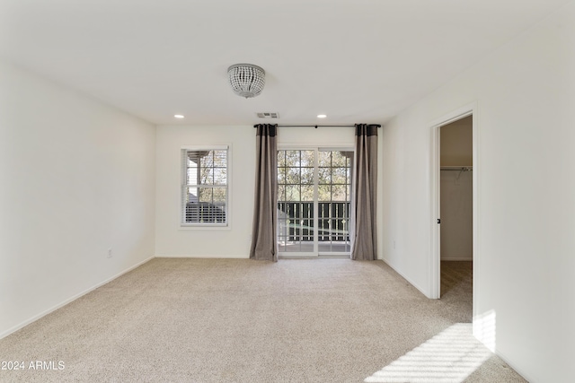 unfurnished room featuring light carpet