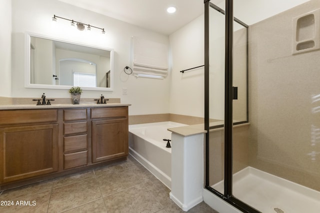 bathroom featuring tile patterned flooring, vanity, and plus walk in shower