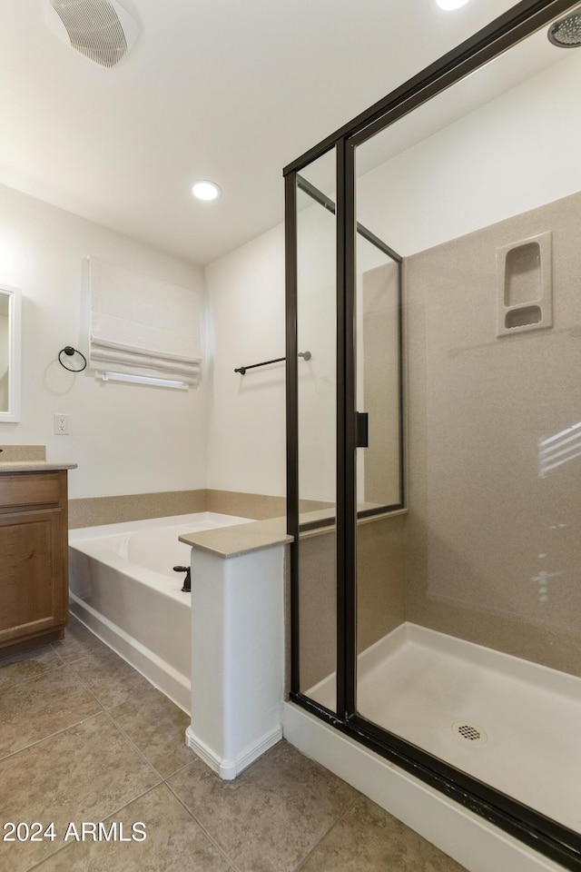 bathroom with tile patterned floors, vanity, and independent shower and bath