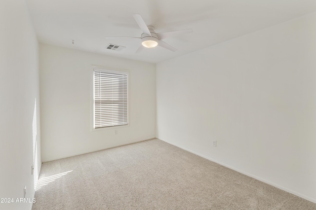 spare room with light carpet and ceiling fan