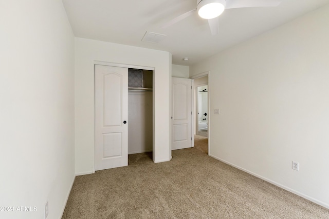 unfurnished bedroom featuring ceiling fan, carpet floors, and a closet