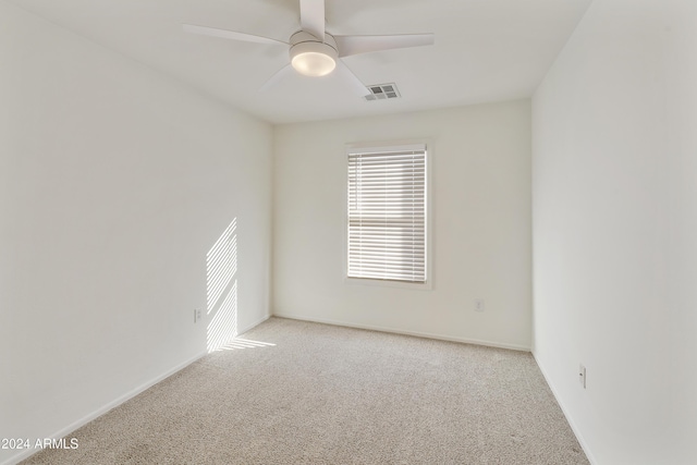 unfurnished room featuring light carpet and ceiling fan