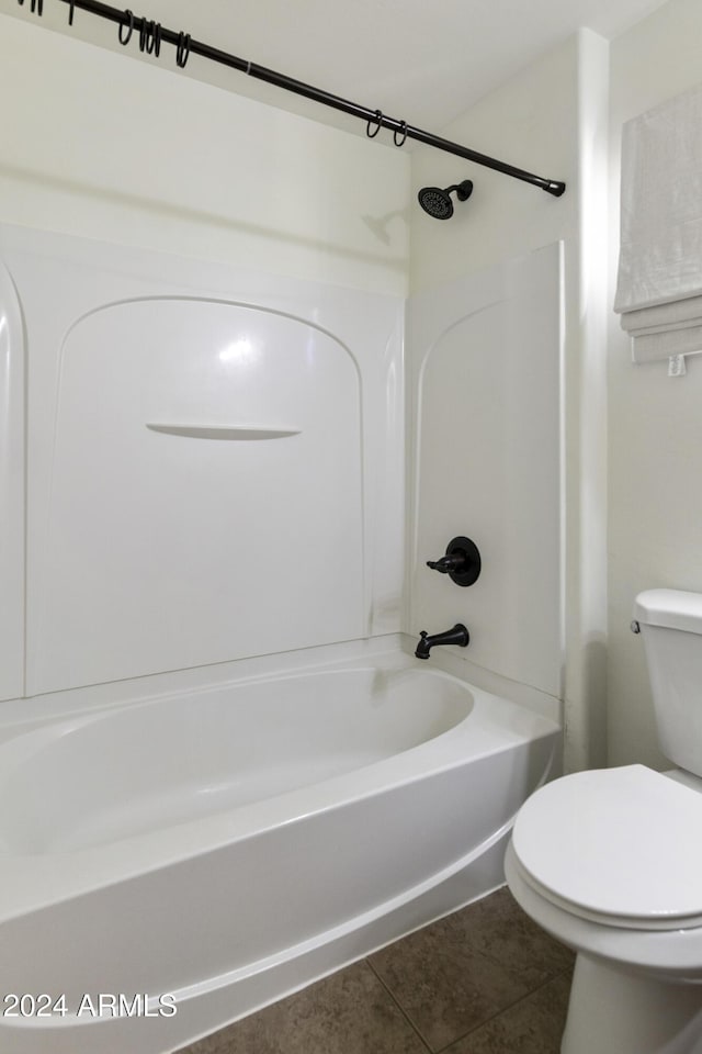 bathroom featuring tile patterned floors, toilet, and bathing tub / shower combination