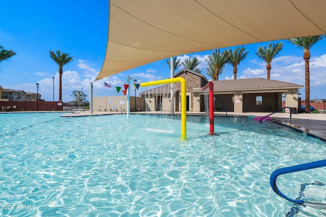 view of swimming pool with pool water feature