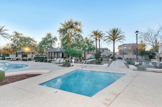 view of swimming pool with a gazebo and a patio area