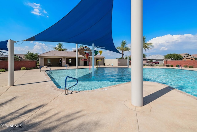 view of swimming pool with a patio