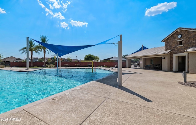 view of swimming pool featuring a patio area