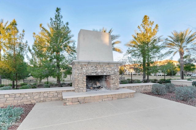 view of patio featuring an outdoor stone fireplace