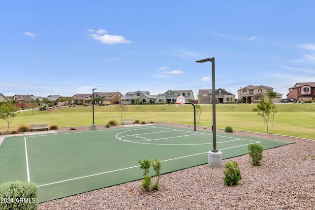 view of basketball court with a yard