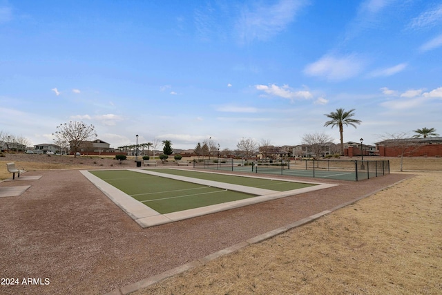 view of property's community with tennis court