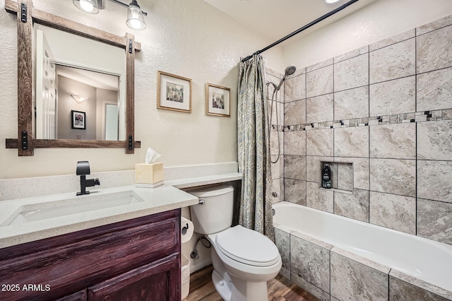 9707 E Mountain View Rd Unit 1408, Scottsdale, AZ 85258 - full bath featuring wood finished floors, toilet, vanity, tiled shower / bath, and a textured wall