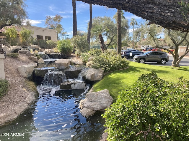 9707 E Mountain View Rd Unit 1408, Scottsdale, AZ 85258 - view of green lawn with a garden pond