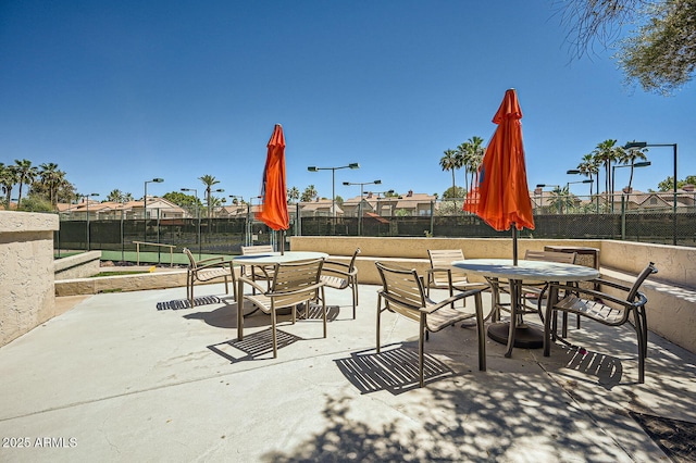 9707 E Mountain View Rd Unit 1408, Scottsdale, AZ 85258 - view of patio featuring outdoor dining area and fence
