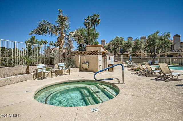 9707 E Mountain View Rd Unit 1408, Scottsdale, AZ 85258 - community pool with a patio area, fence, and a hot tub