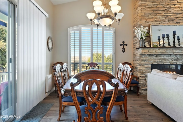 601 E Phoenix St, Payson, AZ 85541 - dining space featuring wood finished floors, a notable chandelier, and a fireplace