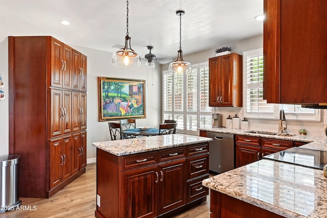 601 E Phoenix St, Payson, AZ 85541 - kitchen featuring decorative light fixtures, a center island, stainless steel dishwasher, a sink, and light wood finished floors