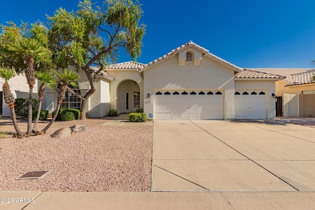1213 W Beck Ln, Phoenix, AZ 85023 - mediterranean / spanish house with an attached garage, concrete driveway, stucco siding, and a tiled roof