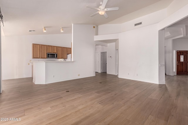 1213 W Beck Ln, Phoenix, AZ 85023 - unfurnished living room with a ceiling fan, light wood-style floors, and high vaulted ceiling