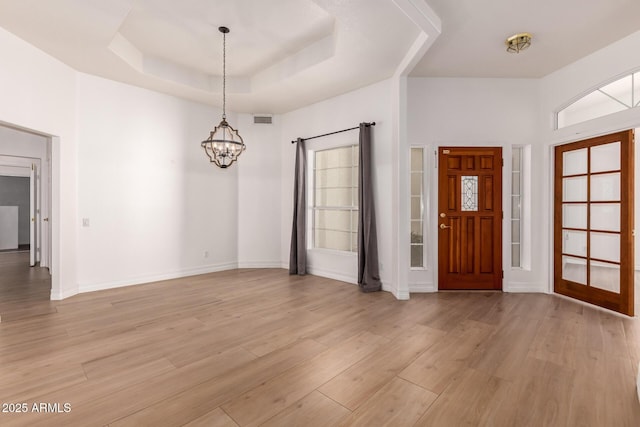 1213 W Beck Ln, Phoenix, AZ 85023 - foyer entrance with a chandelier, light wood-type flooring, and a tray ceiling