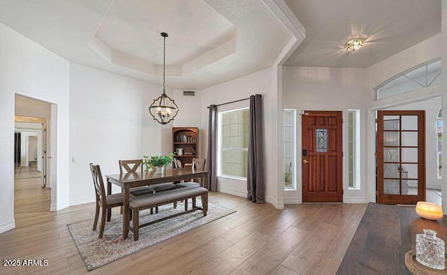 1213 W Beck Ln, Phoenix, AZ 85023 - foyer entrance with a chandelier, light wood-style floors, and a raised ceiling