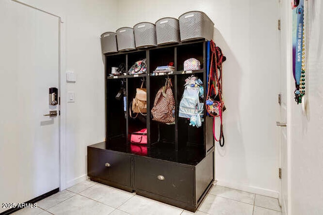 mudroom with tile patterned floors and baseboards