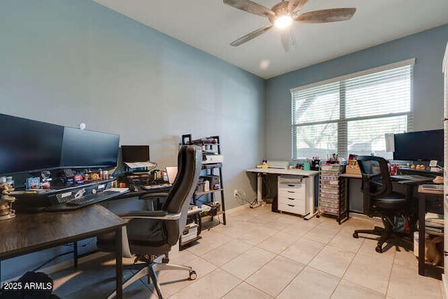 office space featuring lofted ceiling, light tile patterned floors, and a ceiling fan