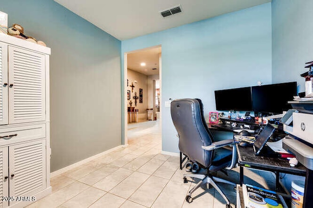 office area with light tile patterned floors, visible vents, and baseboards