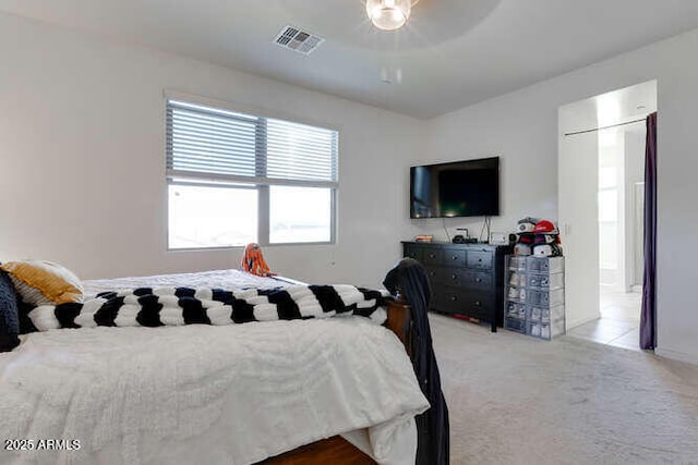 bedroom featuring visible vents, carpet floors, and a ceiling fan