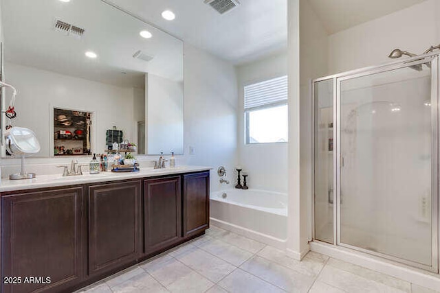 bathroom with visible vents, a stall shower, a garden tub, and double vanity