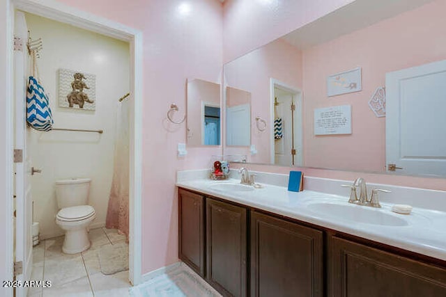 full bathroom featuring a sink, toilet, double vanity, and tile patterned floors