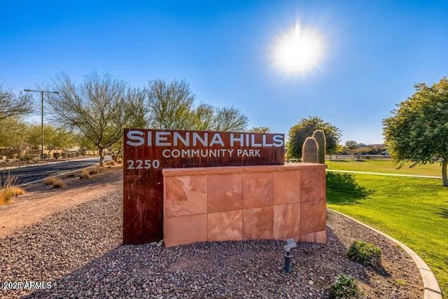 community / neighborhood sign with a yard