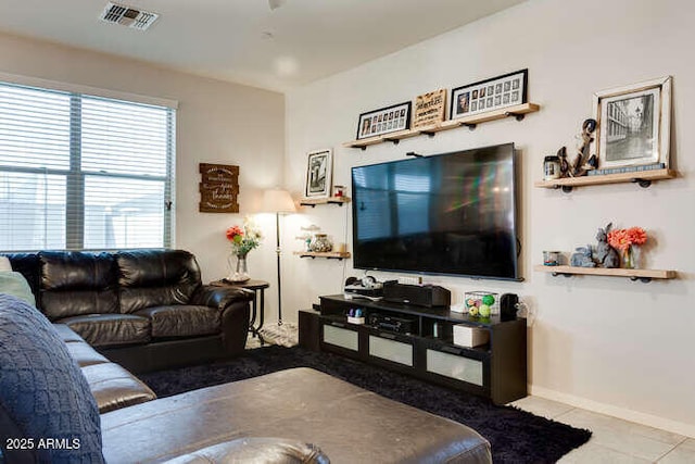 living area featuring visible vents, baseboards, and tile patterned flooring