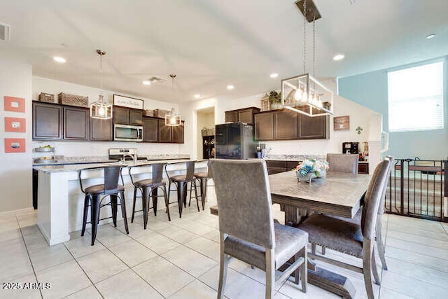 dining room with light tile patterned flooring, visible vents, and recessed lighting