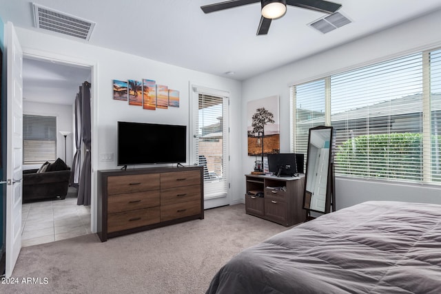 bedroom featuring light carpet and ceiling fan