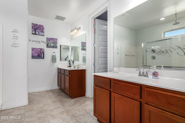 bathroom with vanity, tile patterned floors, and a shower with door