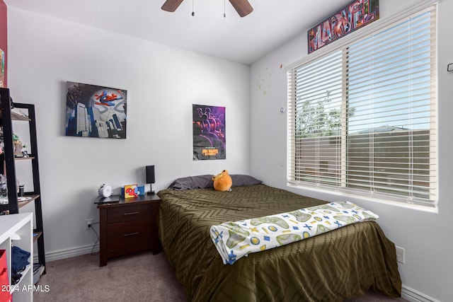 bedroom featuring ceiling fan and carpet