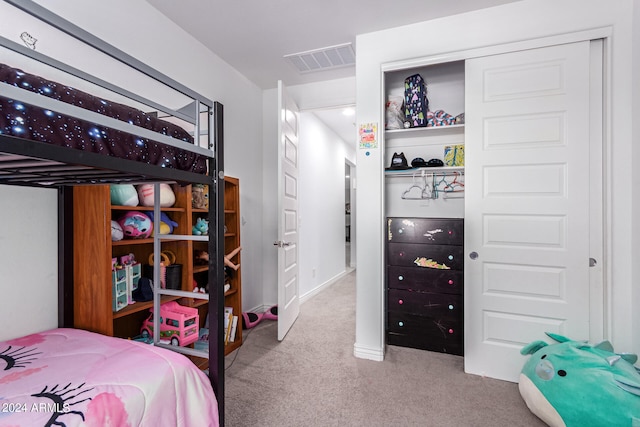 bedroom featuring light carpet and a closet