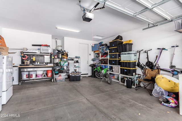 garage featuring a garage door opener and a workshop area